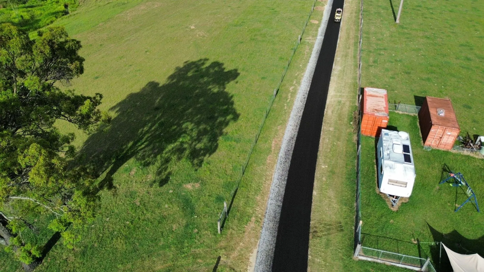 Aerial view of a newly paved bitumen driveway on a rural property.